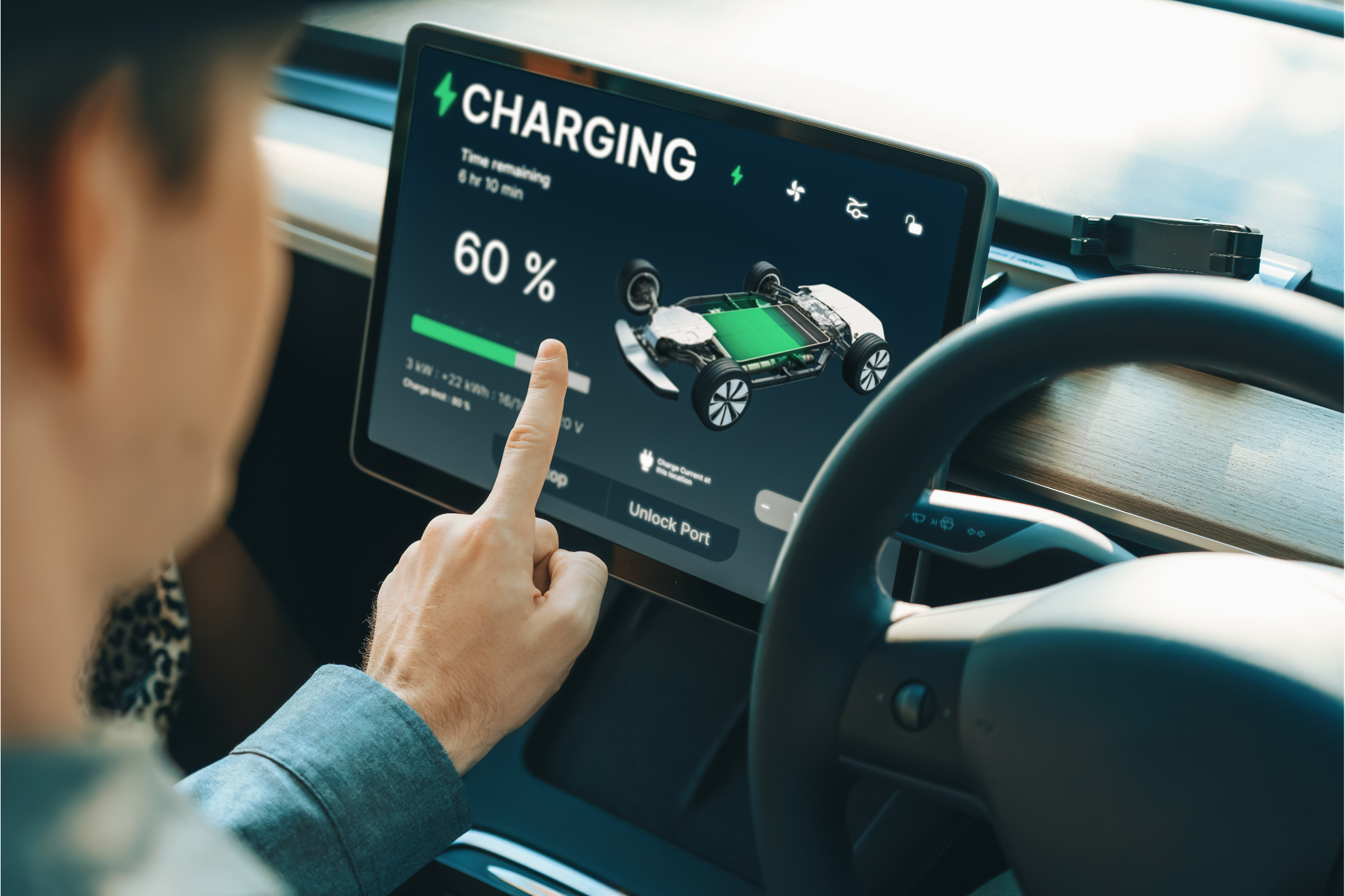 Person in connected car touching screen showing 60% charging status with an image of a vehicle and battery. - CSA Catapult